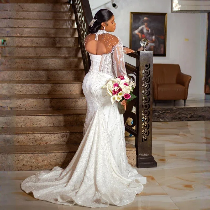 Maßgeschneiderte Aso Ebi High Neck Shinny Kristalle Perlen Brautkleid Robes De Mariee Lange Ärmel Open Back Meerjungfrau Brautkleider