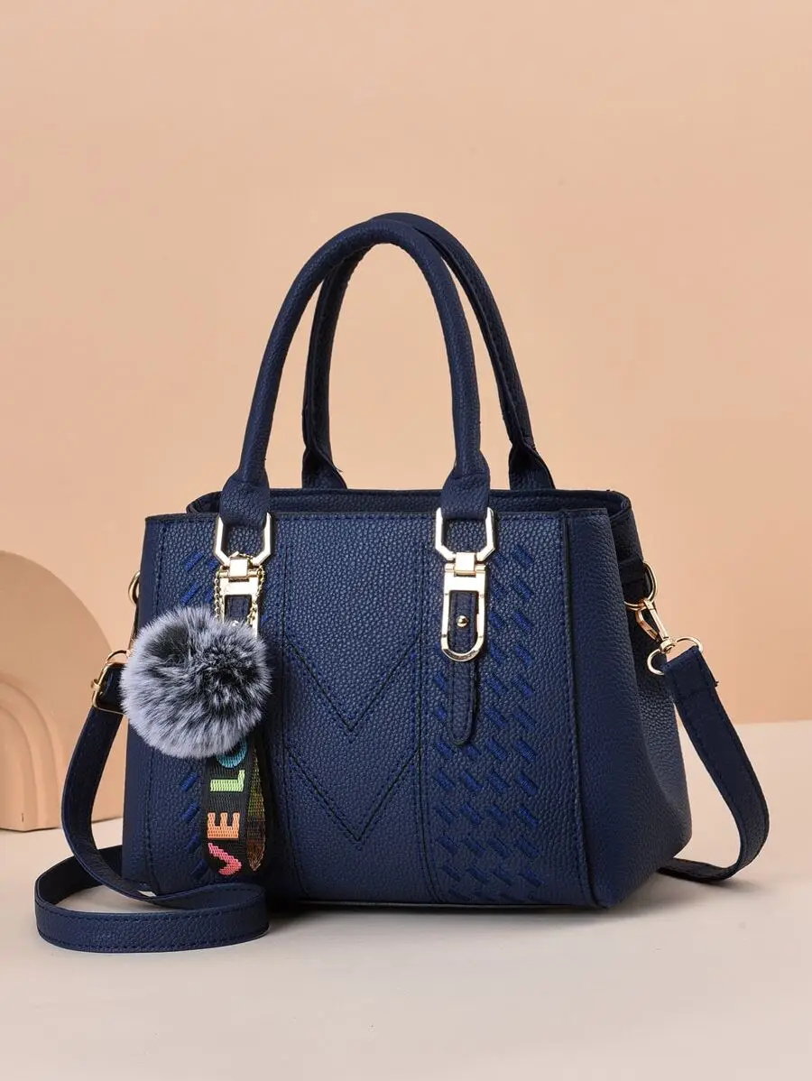 

Navy Blue Top-Handle Bag with Embossed Pattern and Pom Pom Charm
