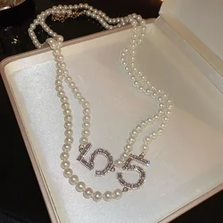 Collana lunga di perle a doppio strato Collana di gioielli con catena di maglione con perline francesi per donna