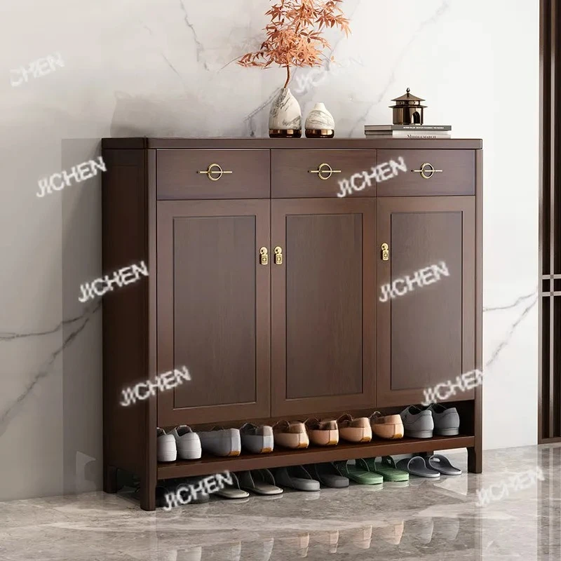 

Black walnut solid wood shoe cabinet at entrance of the household, and the entrance door is against wall.
