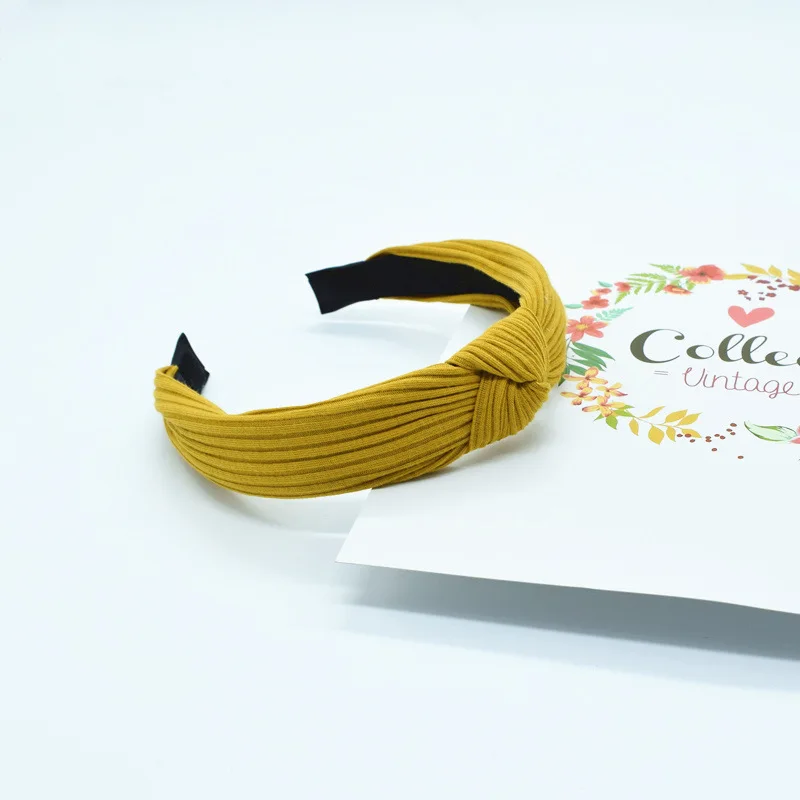 

High-end solid-colour fabric hand-woven cross-knot hairband with wide hairband and cross-knot hair accessory.