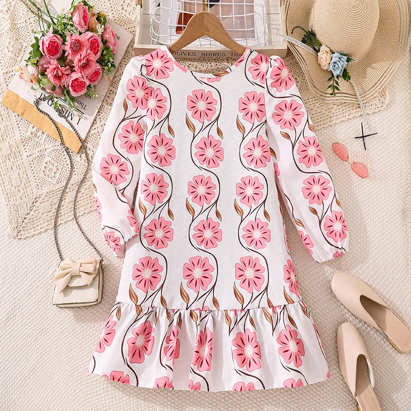 

This charming pink floral dress for girls aged 8-12 features a delicate bow neck, 3/4 puff sleeves, and a ruffled hem. Made from