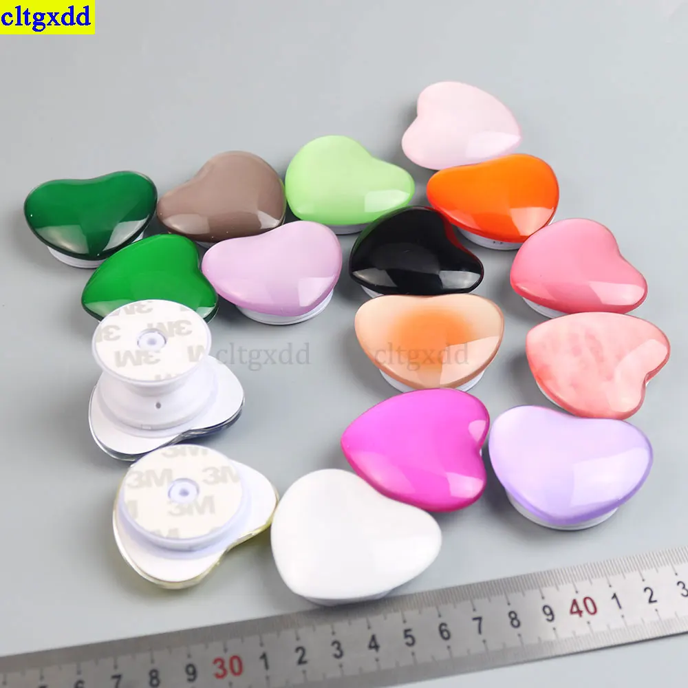 Cltgxdd, 1 pieza, pegamento transparente en forma de gota, soporte para teléfono 3D brillante en forma de corazón, soporte para airbag, agarre universal para teléfono plegable estirable