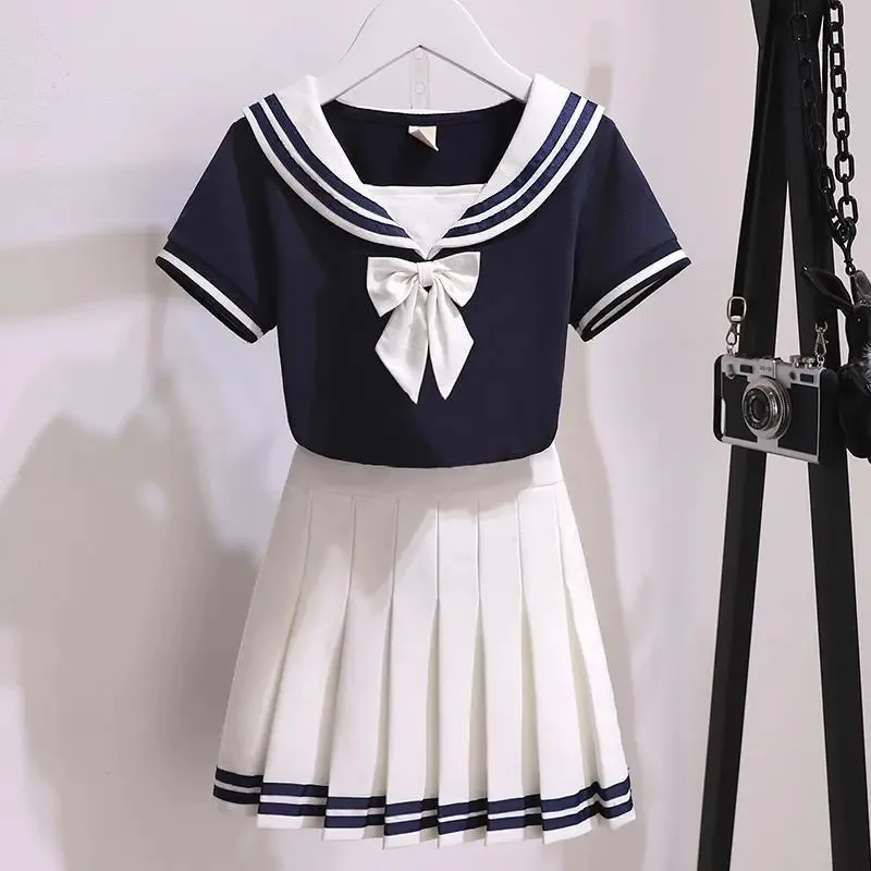 Uniforme JK blanco y negro de verano para niñas, camisa de manga corta + faldas plisadas, uniformes escolares japoneses, falda estilo azul marino, conjunto de dos piezas