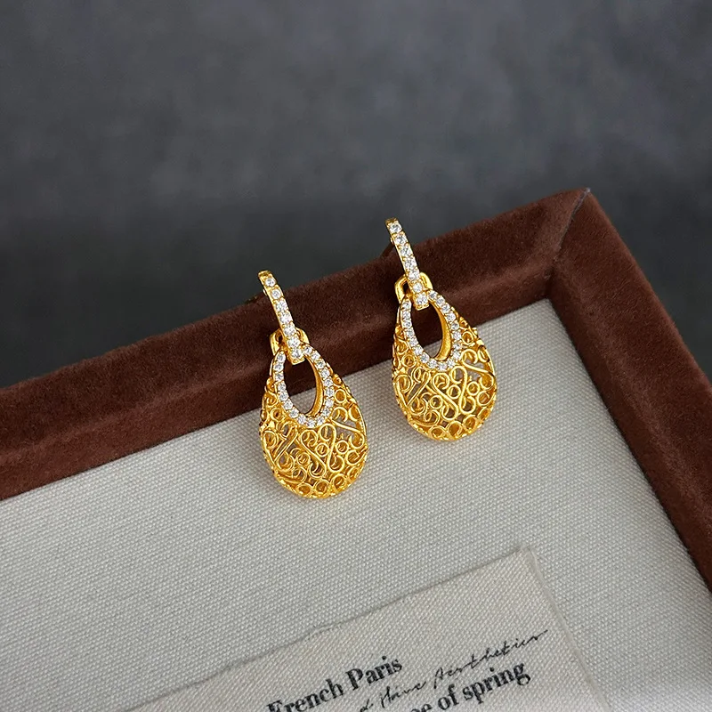 9999 gold luxury hollow magic sachet stud earrings for women, high-end, European style, elegant and fashionable drop earrings