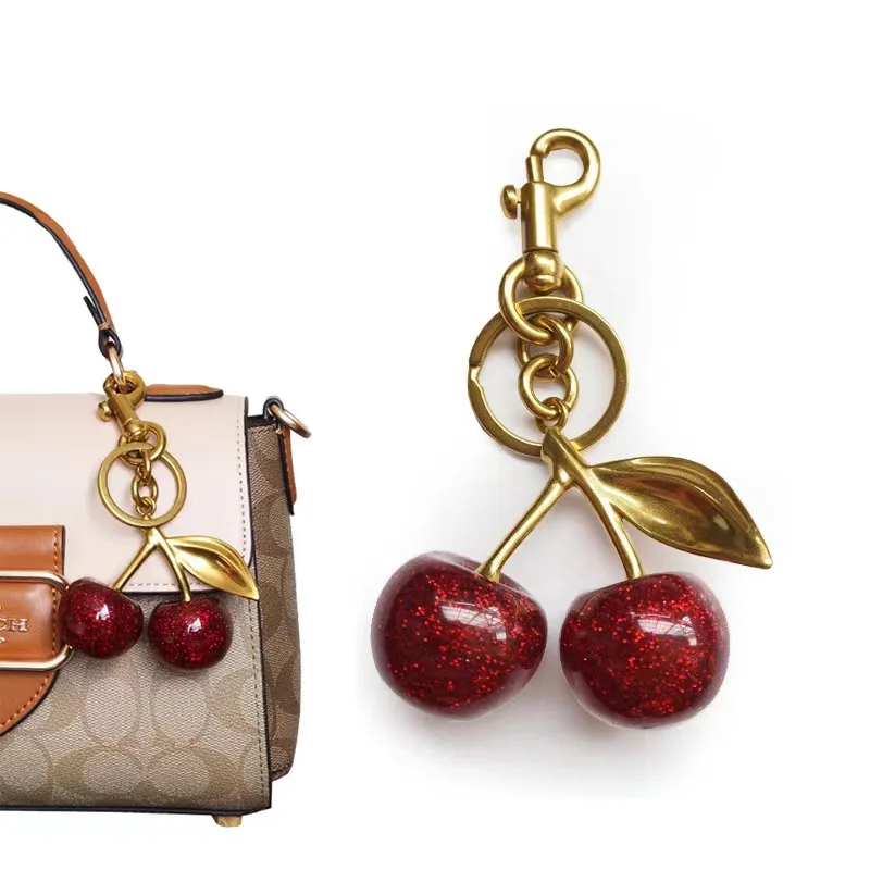 

Golden Cherry Keychain Charm - Shiny Resin & Metal Bag Accessory, Elegant Gift for Women, Purse or Handbag Decoration