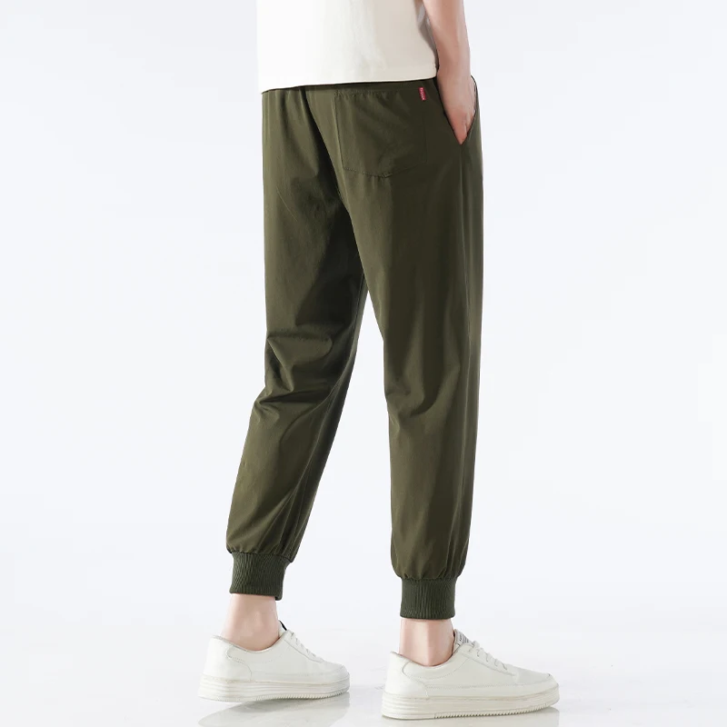 Pantalones informales versátiles para hombre, pantalones deportivos de seda de hielo de secado rápido, elásticos de cuatro lados, nailon juvenil,