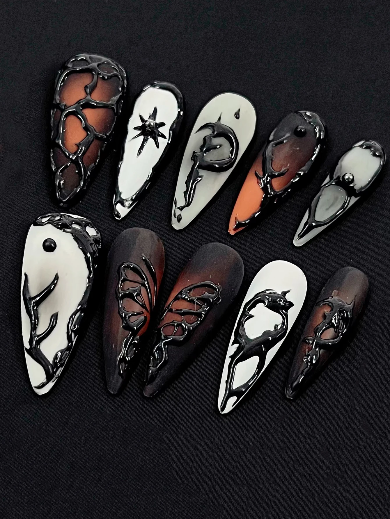 Set of 10 handcrafted press-on nails featuring a sophisticated, dark aesthetic; minimalist design; reusable; suitable for daily