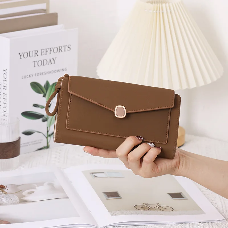 

PU ladies' long three-fold multi-slot simple solid-color clasp large-capacity multi-purpose portable travel wallet