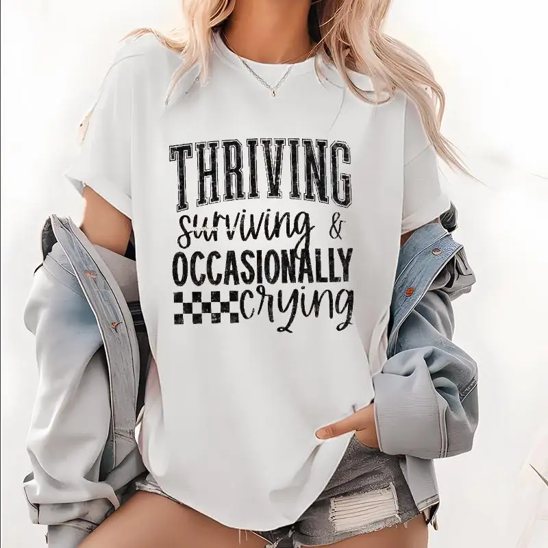 

Trendy Washed Tee with Empowering Phrase "Thriving, Surviving & Occasionally Crying" for a Chic Vibe