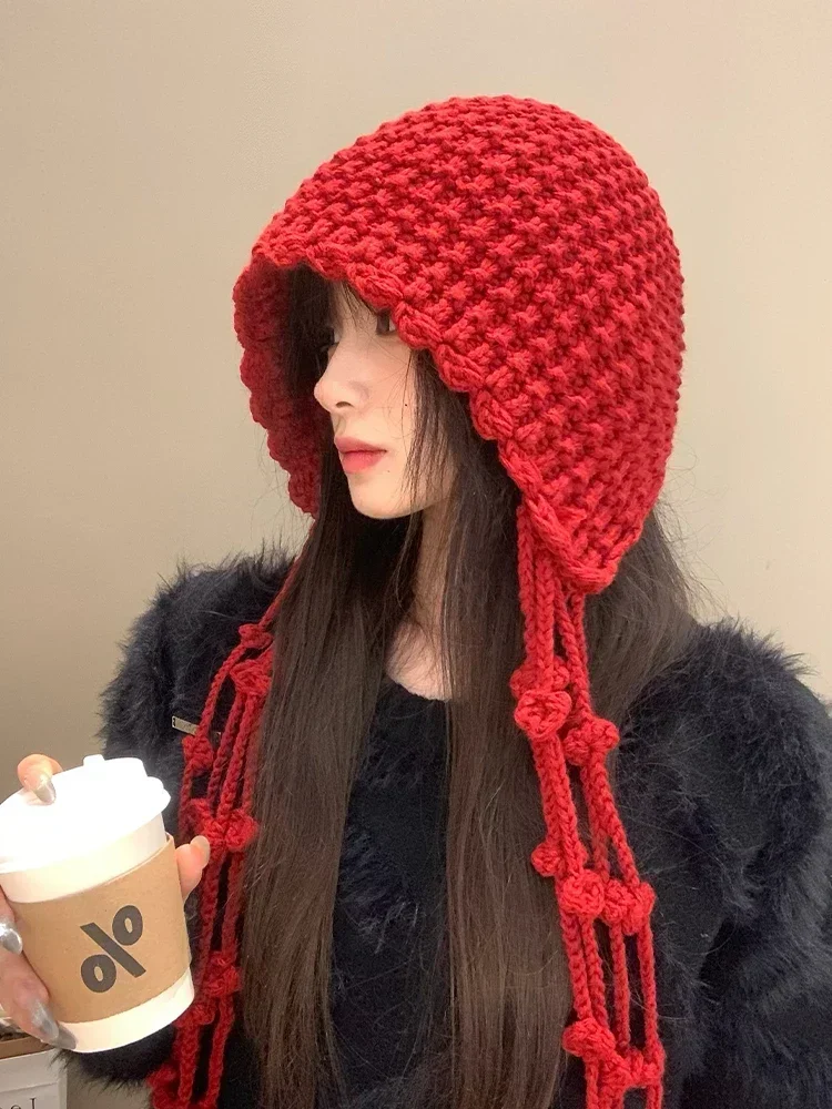 Hand woven tassel ball red knitted toe cap for women in autumn and winter, providing warmth and ear protection