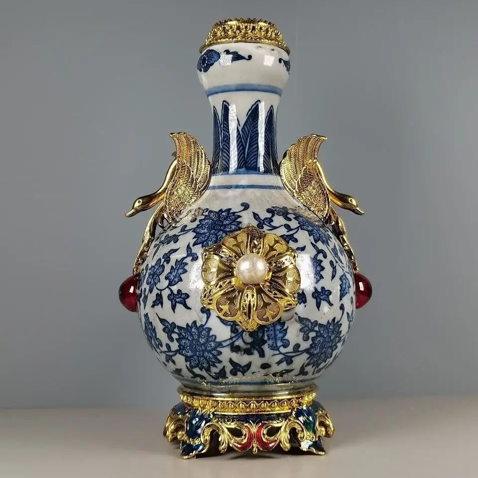 A replica of a Qianlong period blue-and-white bronze-inlaid gemstone appreciation vase made in China