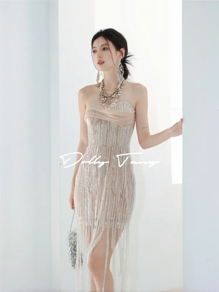 

A short dress with sequined strapless design and sparkling tassels