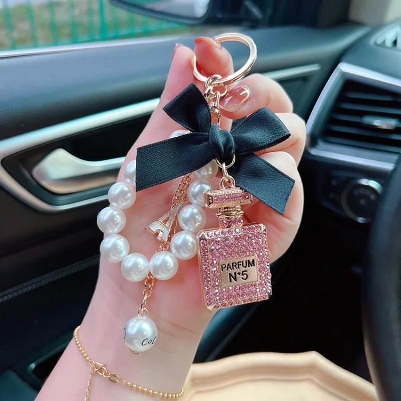 Alloy diamond inlaid bow shaped perfume bottle key chain creative pearl chain bag pendant exquisite key chain image 2