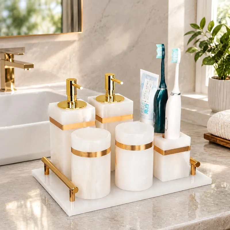 elegant-white-onyx-marble-bathroom-accessories-featuring-gold-soap-pump-toothbrush-stand-and-cotton-swab-container