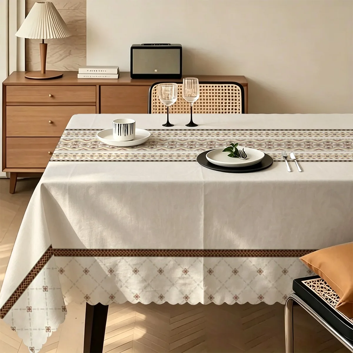 A rectangular tablecloth featuring a pattern of ethnic geometric rhombus-shaped stripes in contrasting colors