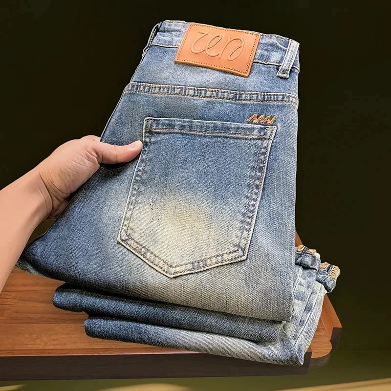 Vaqueros de mezclilla rasgados de nueve puntos para hombre en el verano de 2026, pantalones elásticos de pierna estrecha lavados retro de marca delgada y de moda