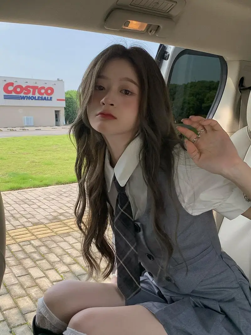 2025 été nouvelle mode femmes corée uniforme style jk robe ensemble gilet chemise courte plissée a-ligne jupe trois pièces jk ensemble