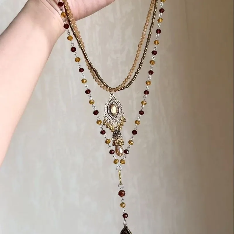 Bohemian-style layered necklace set, featuring two pieces, with an ethnic-inspired long sweater chain and a clavicle chain