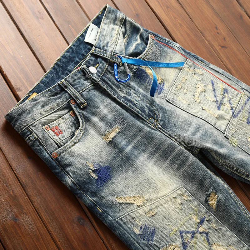 Heavy duty retro jeans for men with ripped patches, contrasting colors, heavy craftsmanship splicing, nostalgic long pants