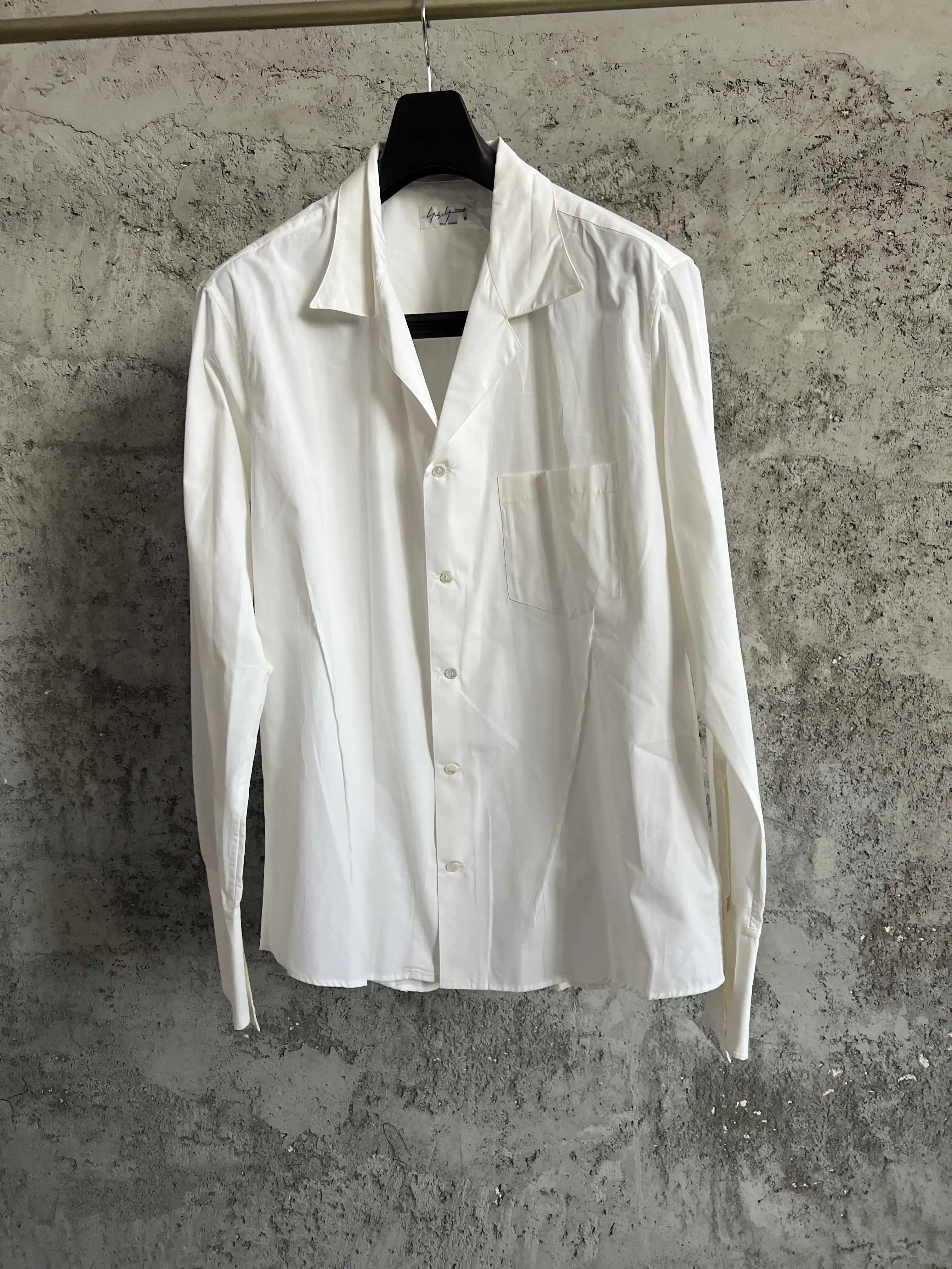 Asymmetrical deconstruction of a white shirt by an original Nordic designer with fringes