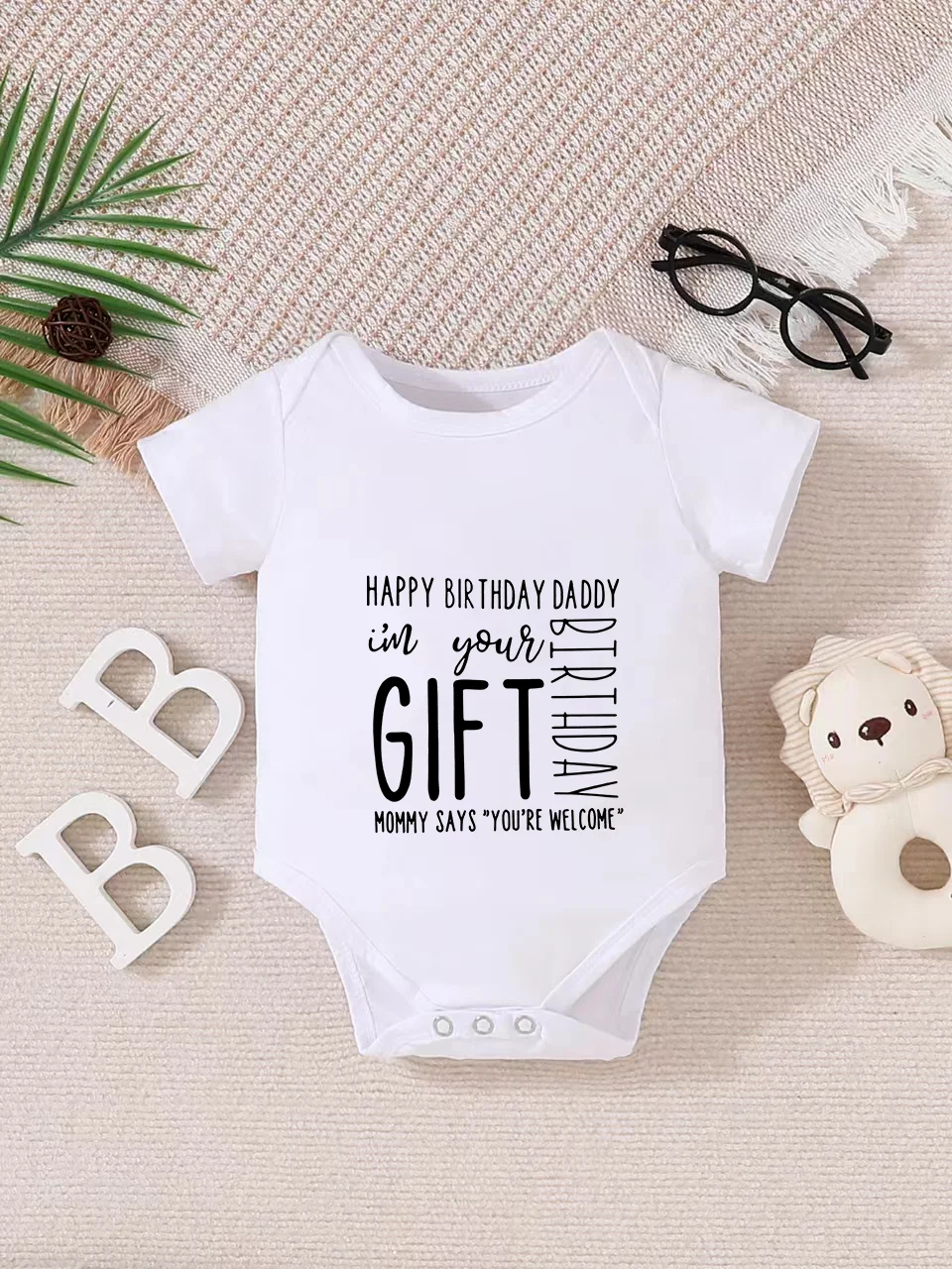 Playful letter-printed baby short-sleeve triangle bodysuit. Button closure for easy dressing, machine washable