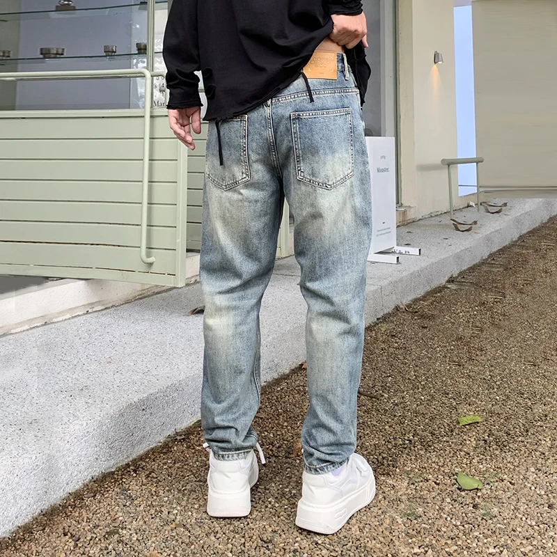 New high-end fashion tapered jeans men influx of loose pants personalized scraping hole patches Harlan pants men's pants