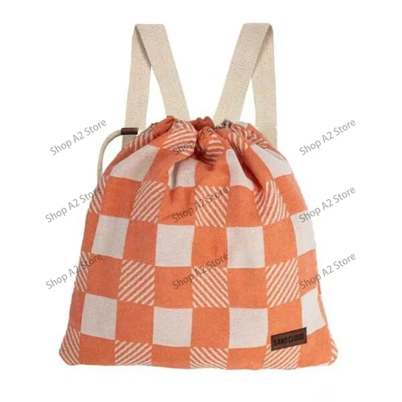 A two-in-one design with a convertible beach towel bag