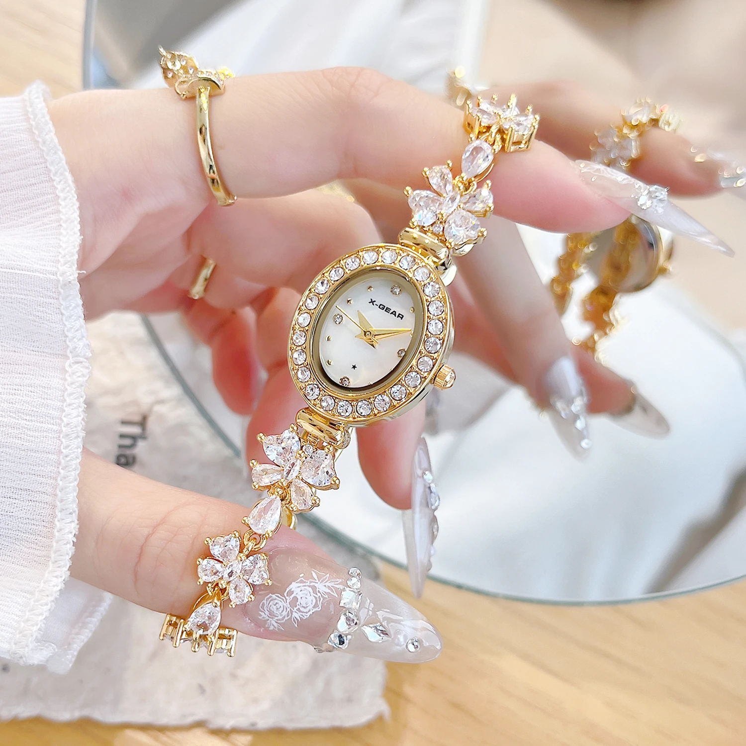 X-GEAR New Fashion Ellipse Ribbon-Strap Diamond-Studded Flower Watch Mother-of-Pearl for Women with Adjustable Bracelet