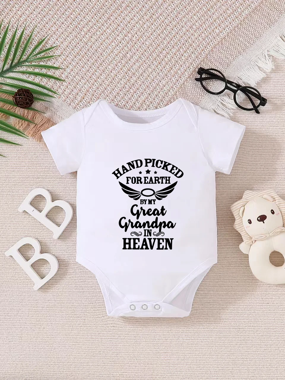Playful letter-printed baby short-sleeve triangle bodysuit. Button closure for easy dressing, machine washable
