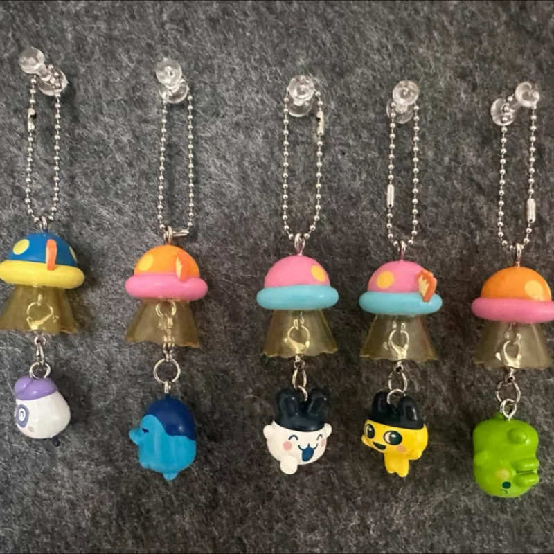 

New Genuine Tamagotchi Ufo Spaceship Shaped String Cute Bag Keychain Twisted Egg Hanging Anime Collectible Peripheral Toys