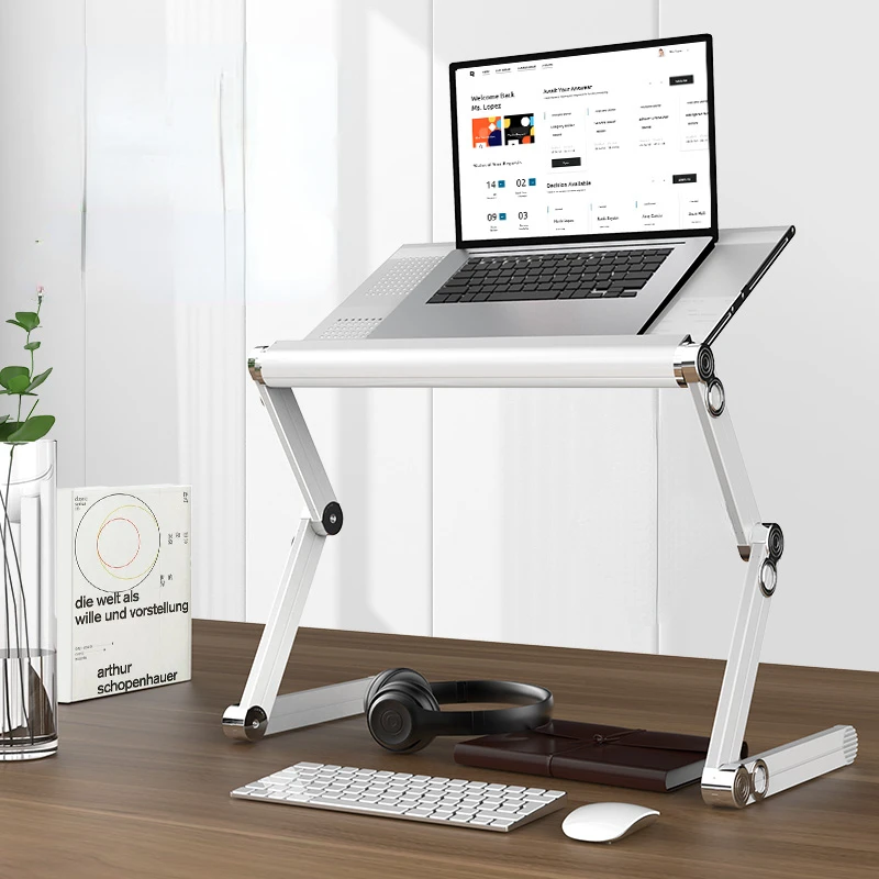 

Lazy people use movable lifting and folding laptop stand on their computer desk and bed