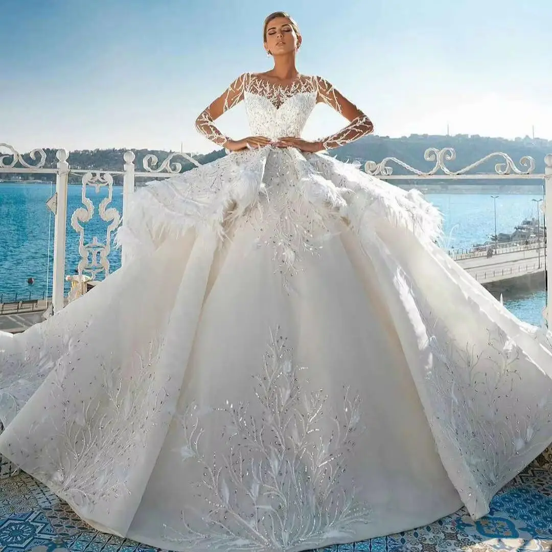 فساتين زفاف مذهلة على شكل كرة ريش كريستال دانتيل فساتين زفاف بدون أكمام مقاس كبير لون فيستدو دي نويفا مخصص