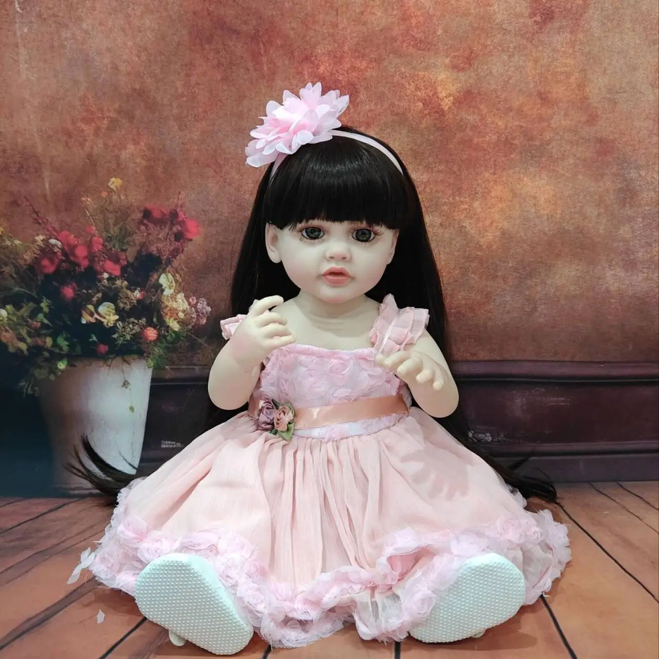 Lifelike 22 - Inch Reborn Baby Doll in Adorable Pink Outfit with Floral Decoration - Perfect for Gifting and Snuggling