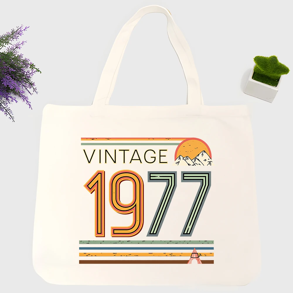 Men's vintage 1977 typography canvas tote bag with retro mountain and sunset graphic, ideal for casual daily use and weekend