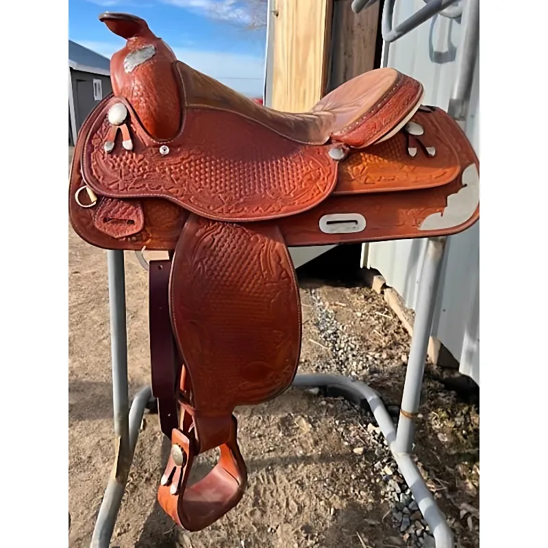 

Handmade maroon carving matching bridle chest strap and other accessories Western saddle