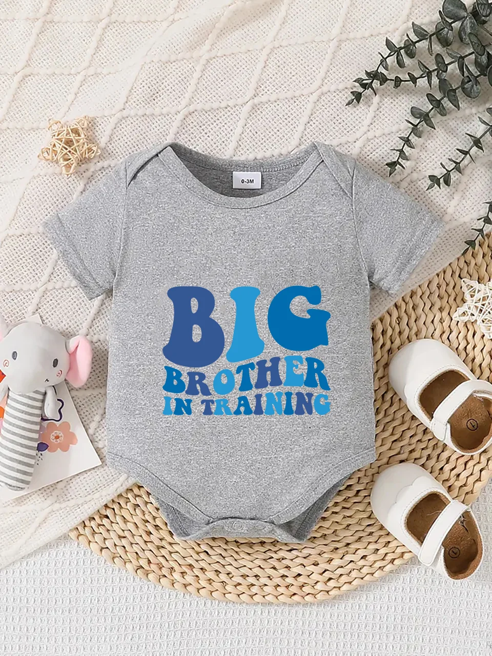 Playful letter-printed baby short-sleeve triangle bodysuit. Button closure for easy dressing, machine washable