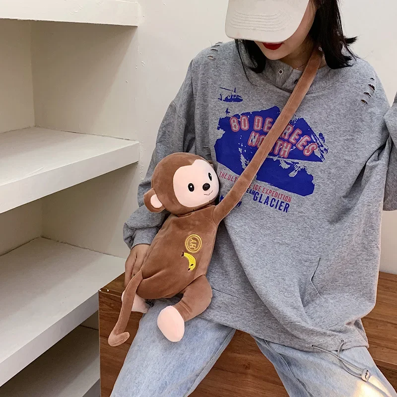 

2024 Female monkey plush doll shoulder bag girl cute cartoon mobile phone bag funny bag