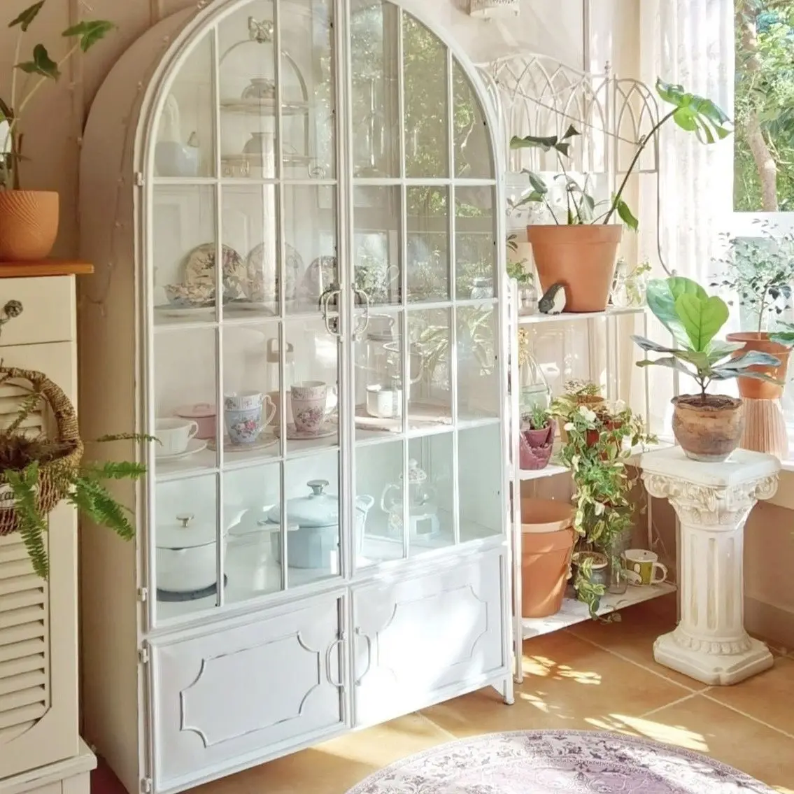 French retro iron arched mesh red bookshelf integrated with wall facing living room, floor standing storage cabinet