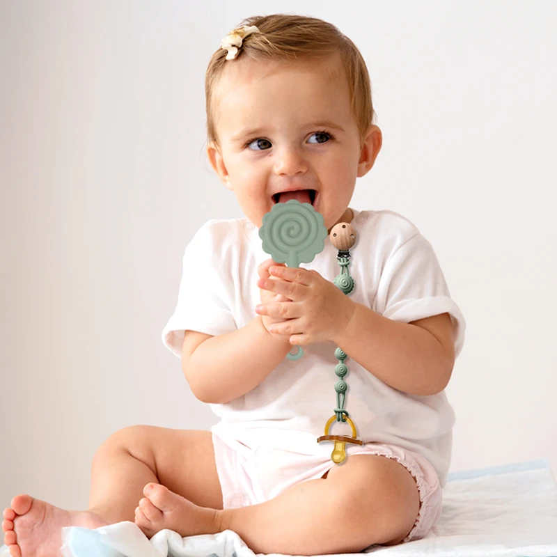 

Cute flower-shaped baby food-grade silicone teether with a one-piece design, featuring a pacifier clip, and BPA-free