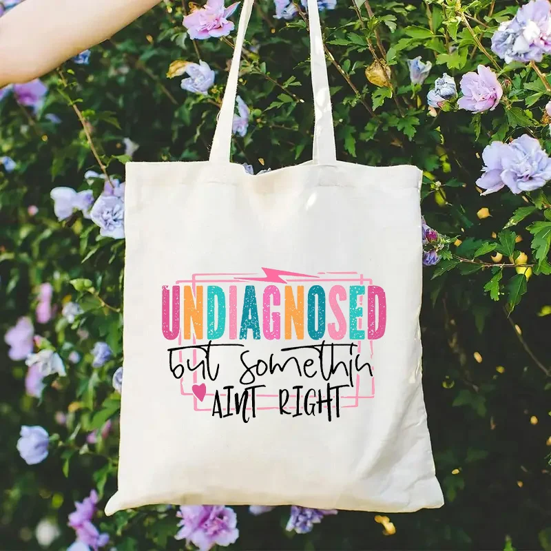 A unique tote bag，Beige background with eye-catching humorous text，Open-top everyday handbag，Suitable for women and non-binary g
