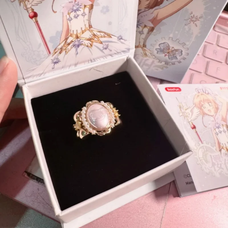 En stock: Caja sorpresa original de anillos transparentes de la chica Sakura de Magic Card, accesorio de moda para juegos, colgante de dibujos animados.