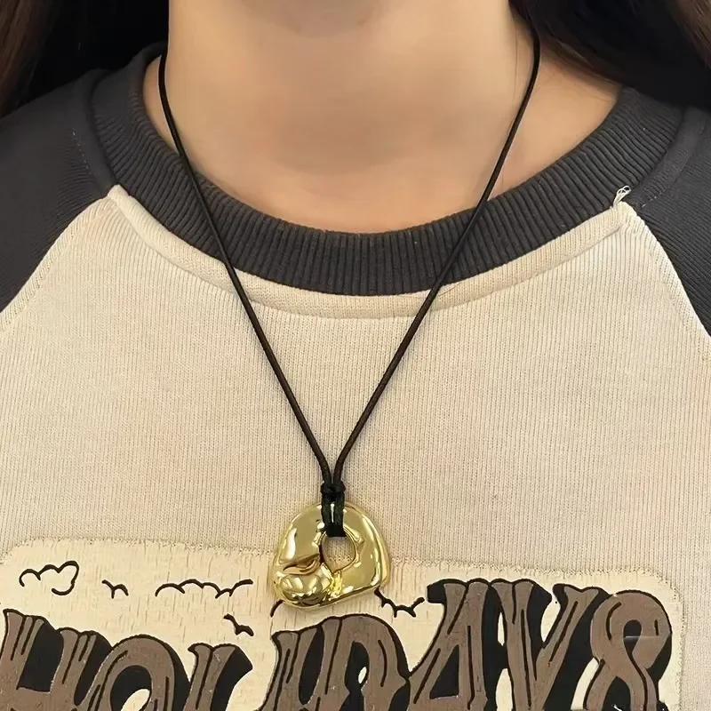 European and American new fashion light luxury niche retro abstract hollow copper plated pendant leather rope adjustable
