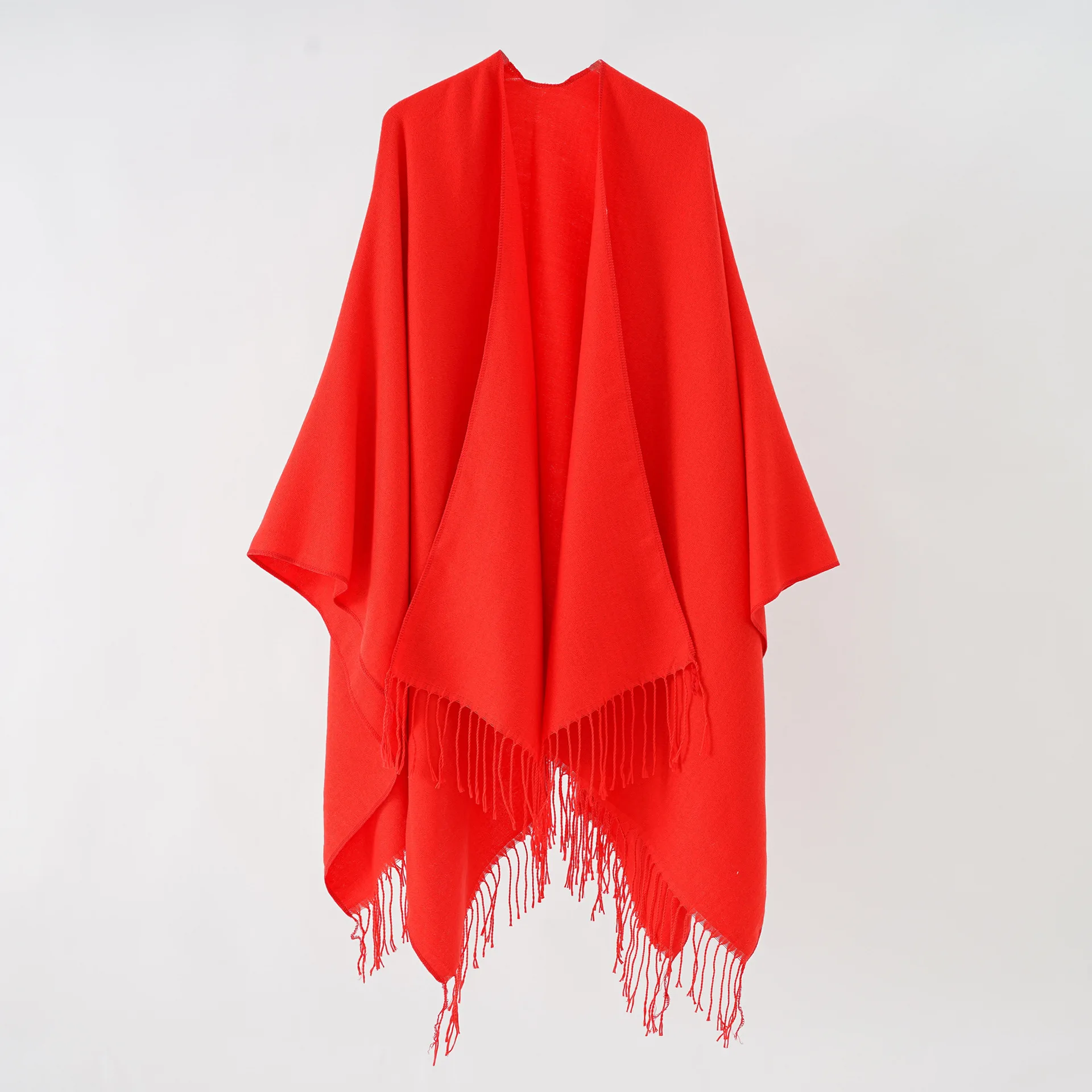 A woman\'s shawl a plain-colored, monochrome cape with a large split shawl and imitation cashmere tassels