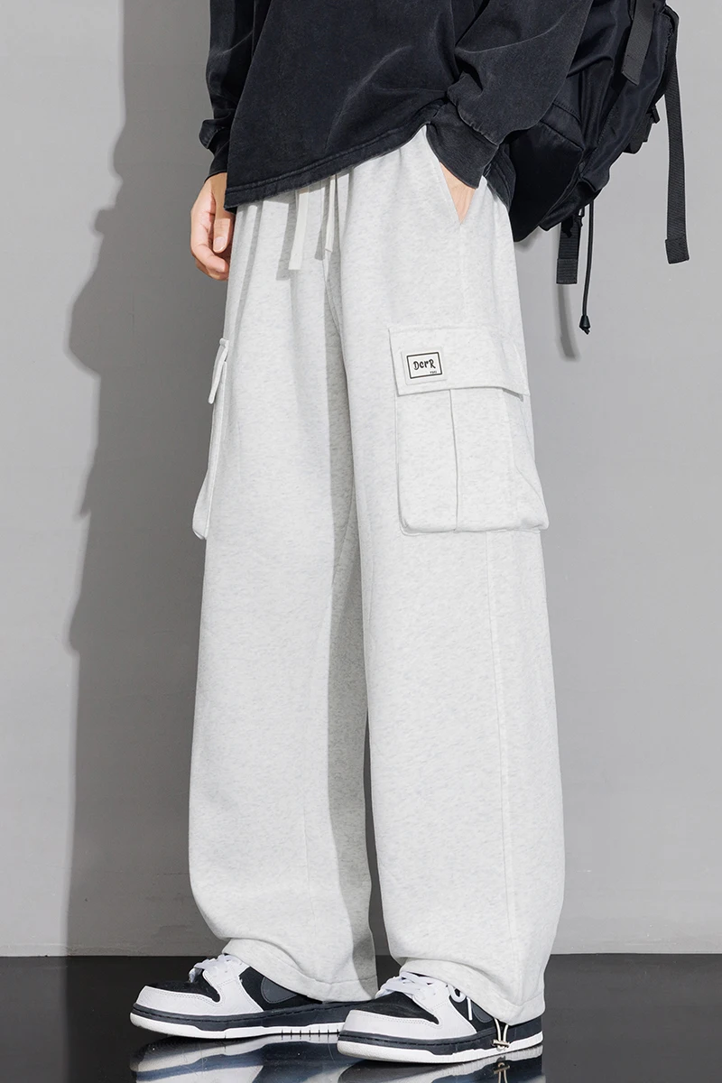 Męskie spodnie dresowe o prostym kroju, typu joggers, do sportu i streetwearu, luźne, oversize'owe, z długimi nogawkami, ze sznurkiem, męskie spodnie z wieloma kieszeniami.