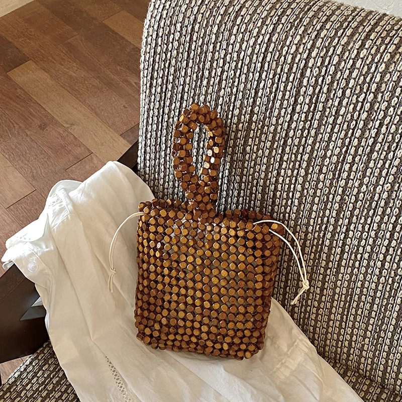 

Handmade Wooden Bead Tote Bag Retro Woven Beaded Top Handle Purse Drawstring Bucket Bag with Natural Wood Beads for Beach