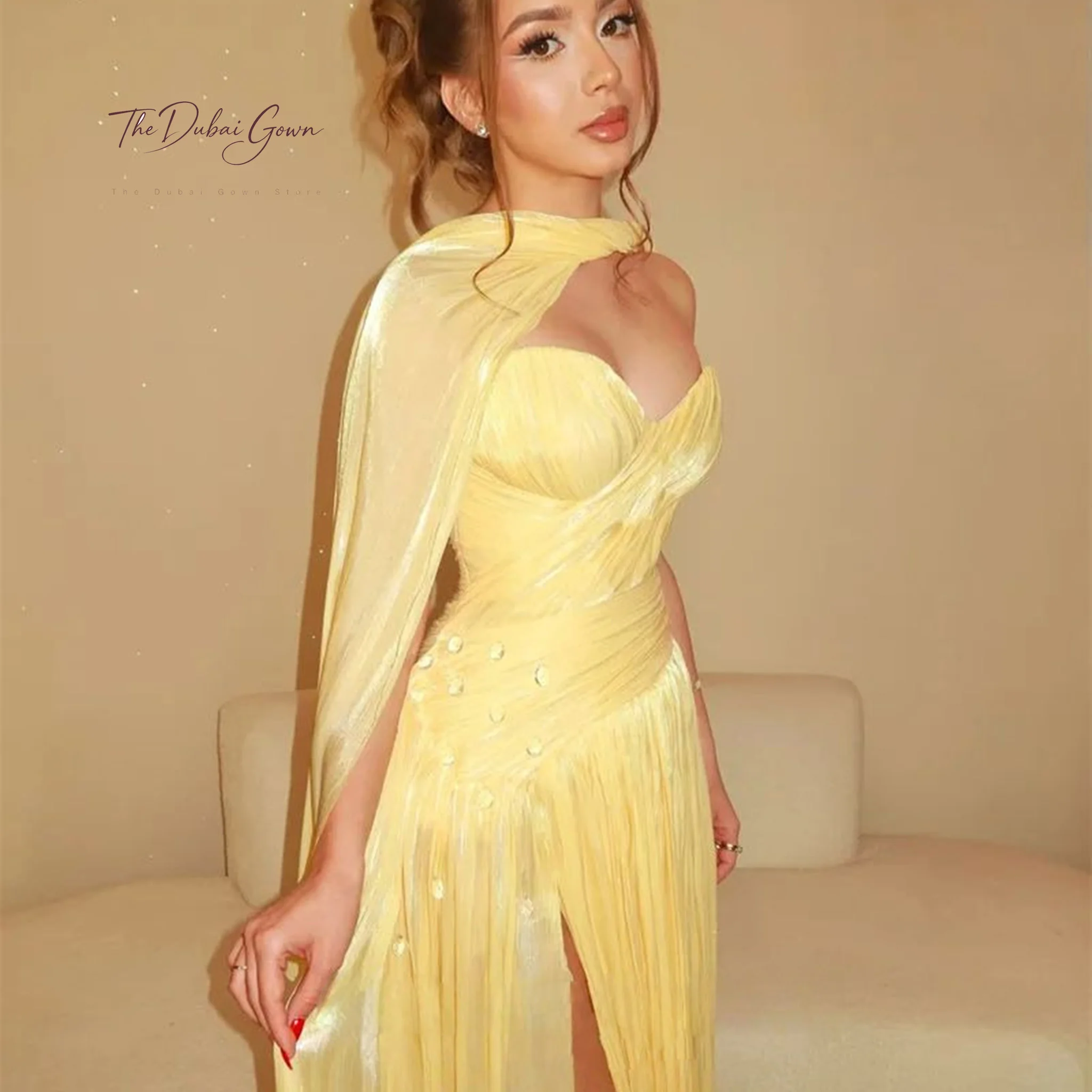 Yellow chiffon strapless floor-length formal gown featuring a pleated bodice and a matching halter-style mini-cape