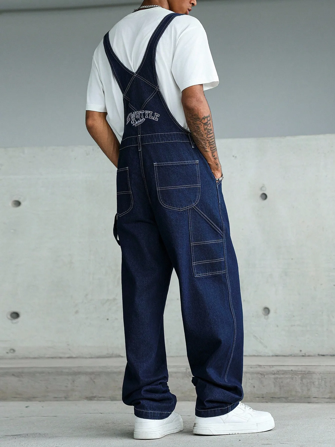 High-quality blue washed multi-pocket denim cargo pants with adjustable shoulder straps, perfect for casual wear in all seasons.