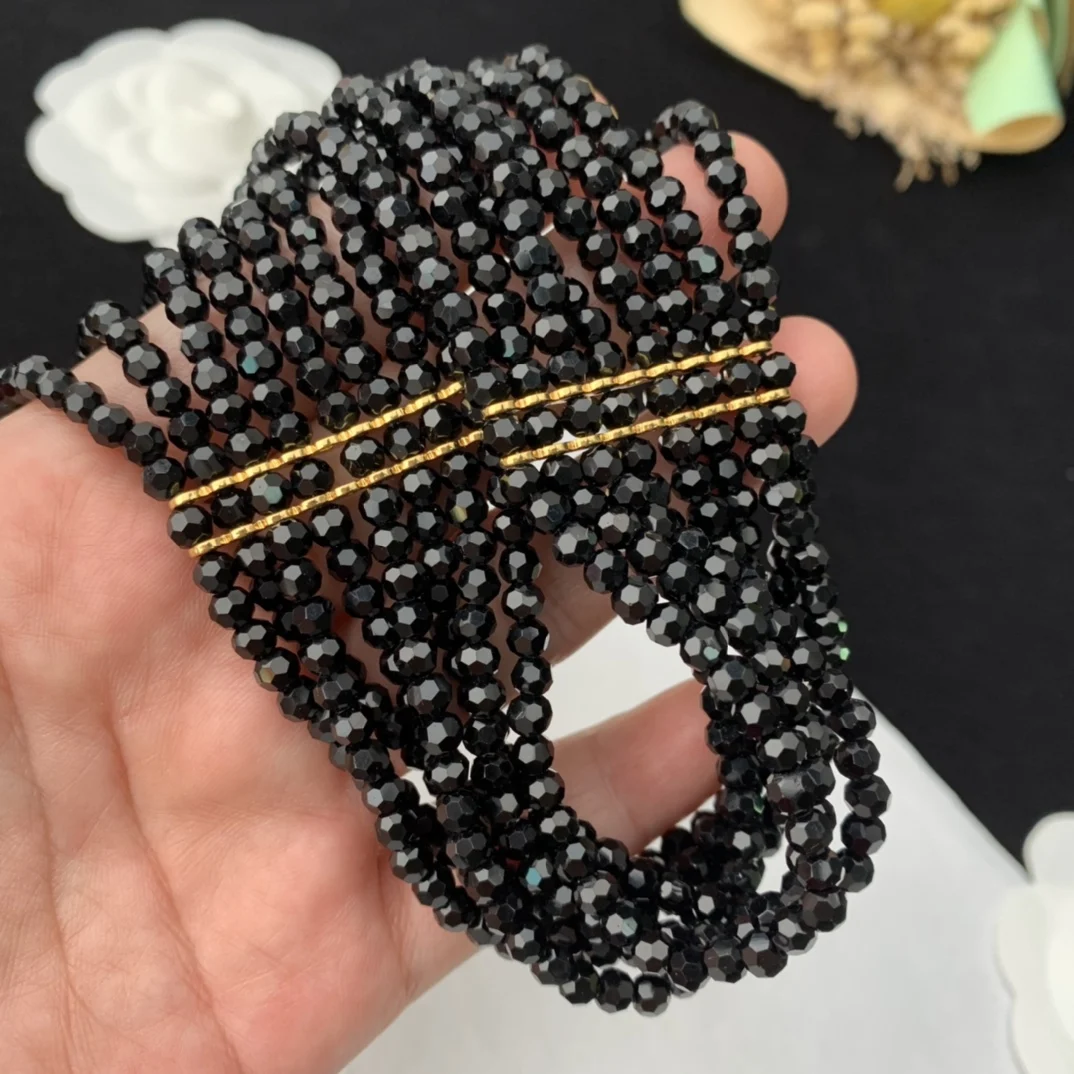 Black multi-layer glass bead necklace woven with elegant flowers paired with a skirt