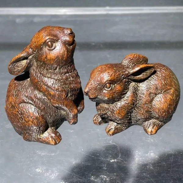 A pair of wind copper rabbits look up  sky and bow down to ground, beckoning fortune, blessings, zodiac rabbits, rabbi